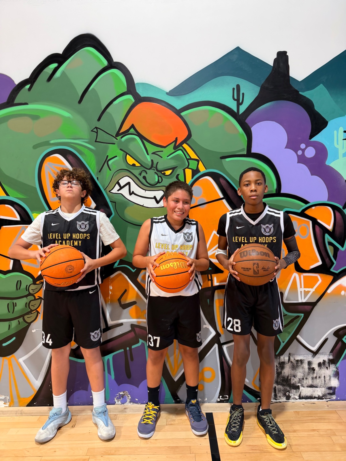 Level Up Hoops athletes in jerseys #34, #37, #28