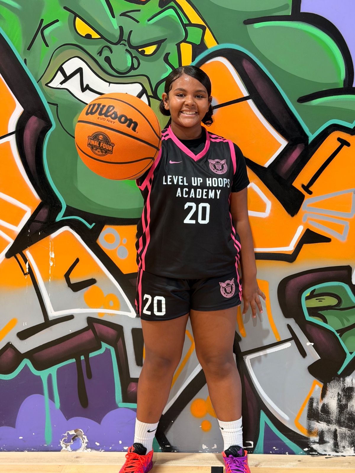 Level Up Hoops girl athlete #20 holding Wilson ball